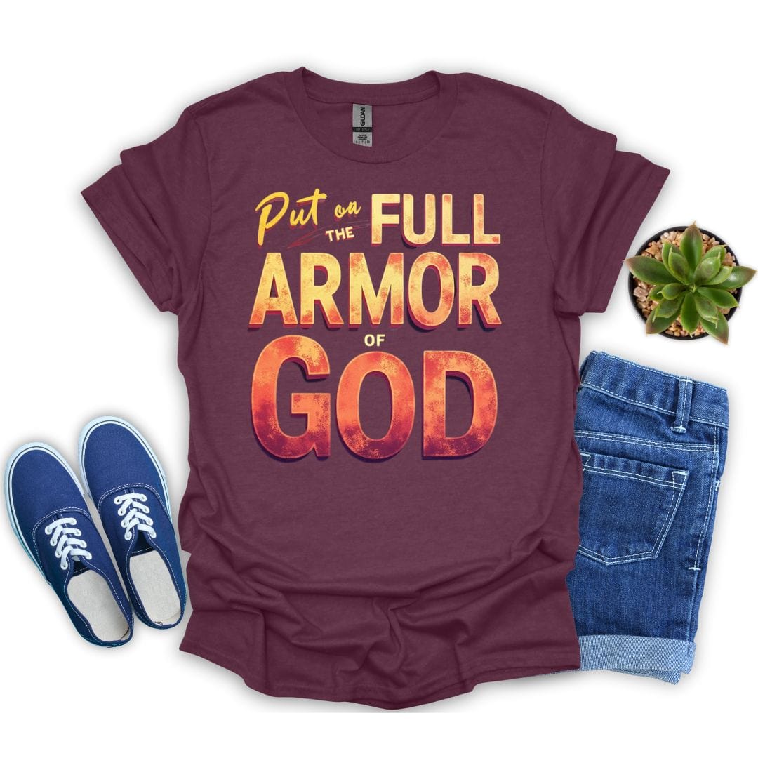 Maroon t-shirt with 'Put on the Full Armor of God' text, blue sneakers, and jeans on a white background