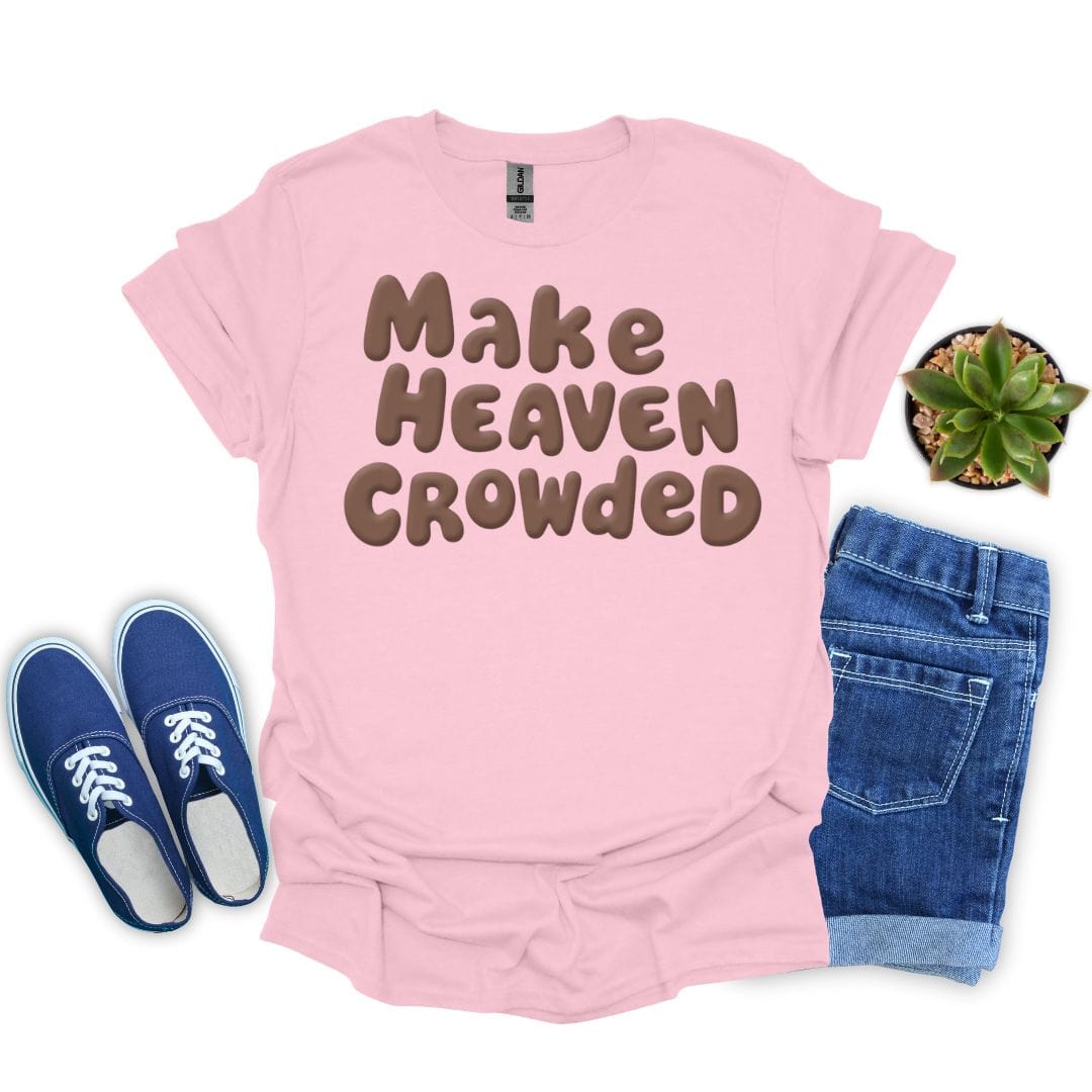 Pink t-shirt with 'Make Heaven Crowded' text, blue sneakers, denim shorts, and a plant on a white background
