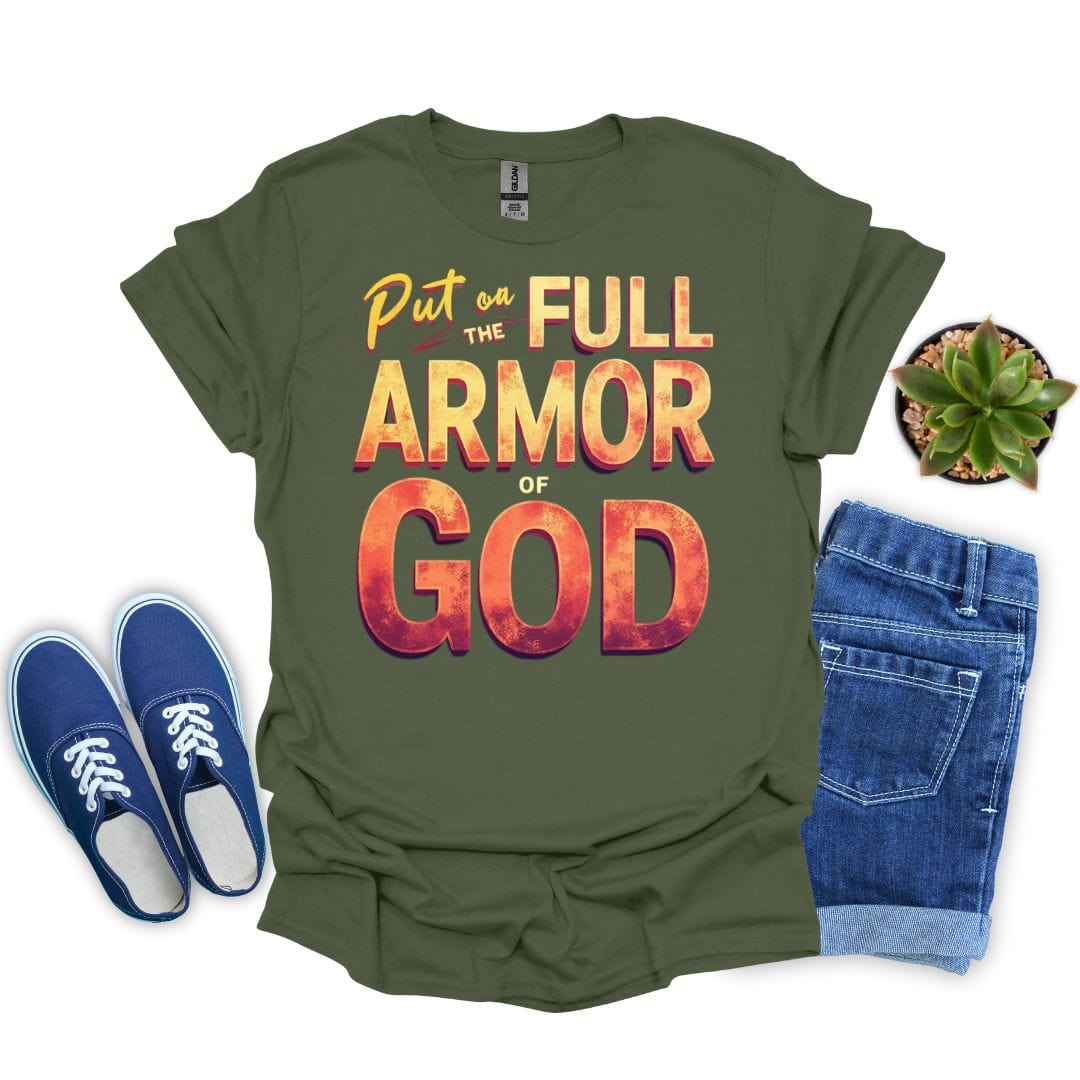 Military green t-shirt with 'Put on the Full Armor of God' text, blue sneakers, and jeans on a white background.