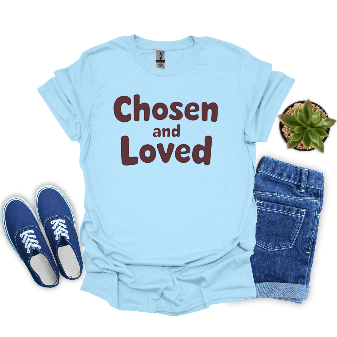 Light blue t-shirt with 'Chosen and Loved' text, paired with blue sneakers and jeans on a white background.