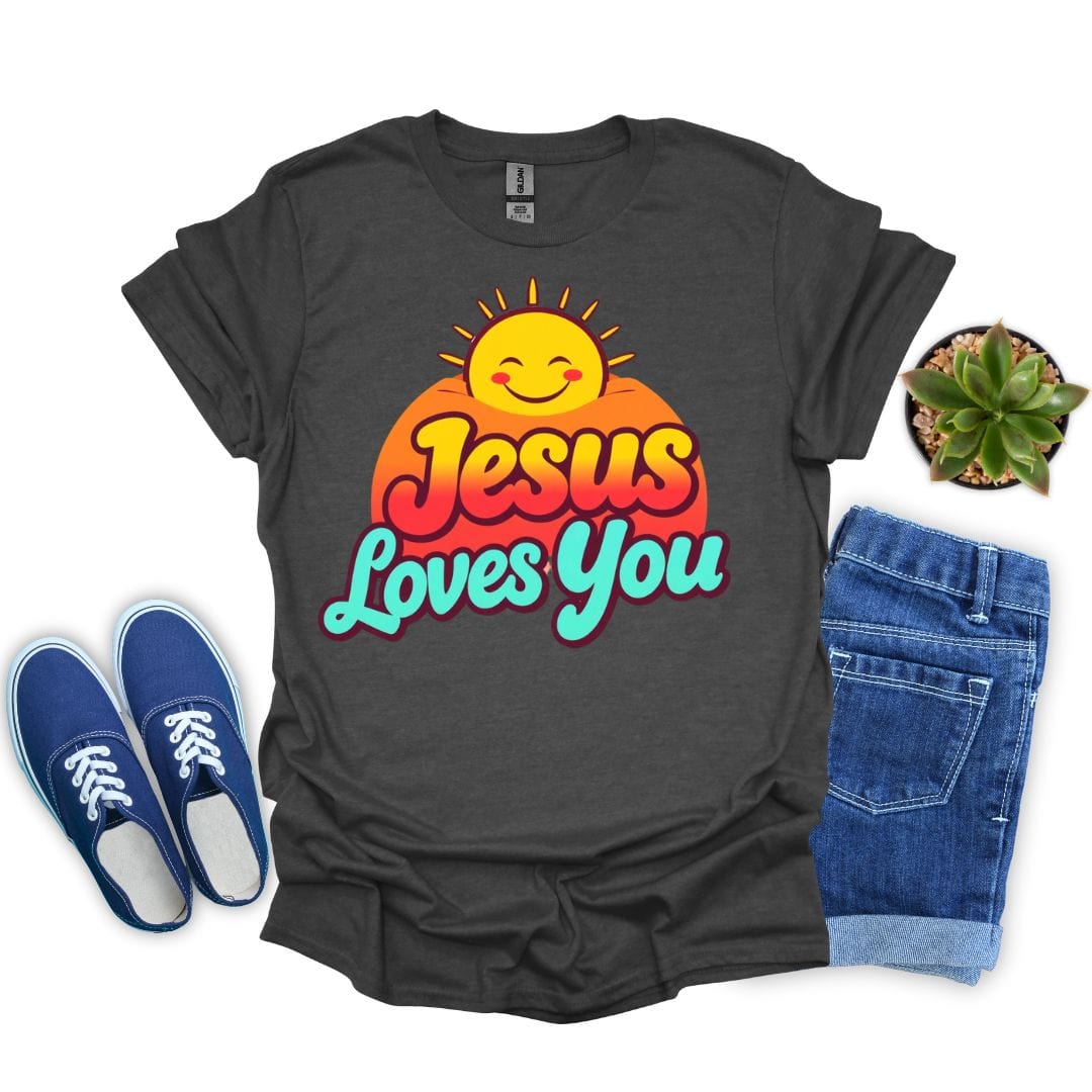 Dark heather t-shirt with 'Jesus Loves You' graphic, blue sneakers, jeans, and a plant on a white background
