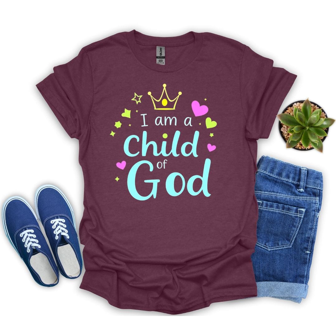 Maroon t-shirt with 'I am a Child of God' text, blue sneakers, and jeans on a white background