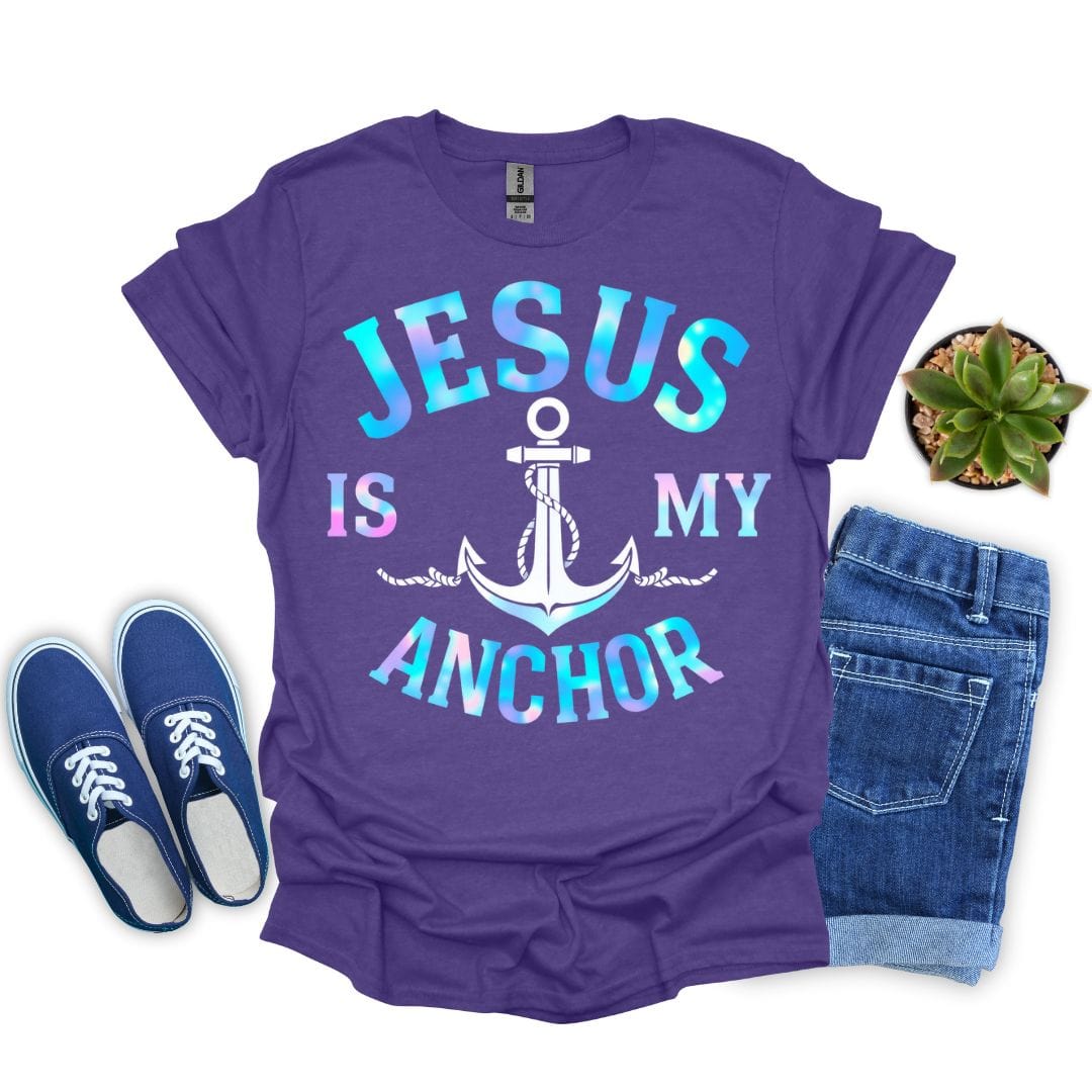 Heather purple t-shirt with 'Jesus is my anchor' design, blue sneakers, denim shorts, and a plant on a white background