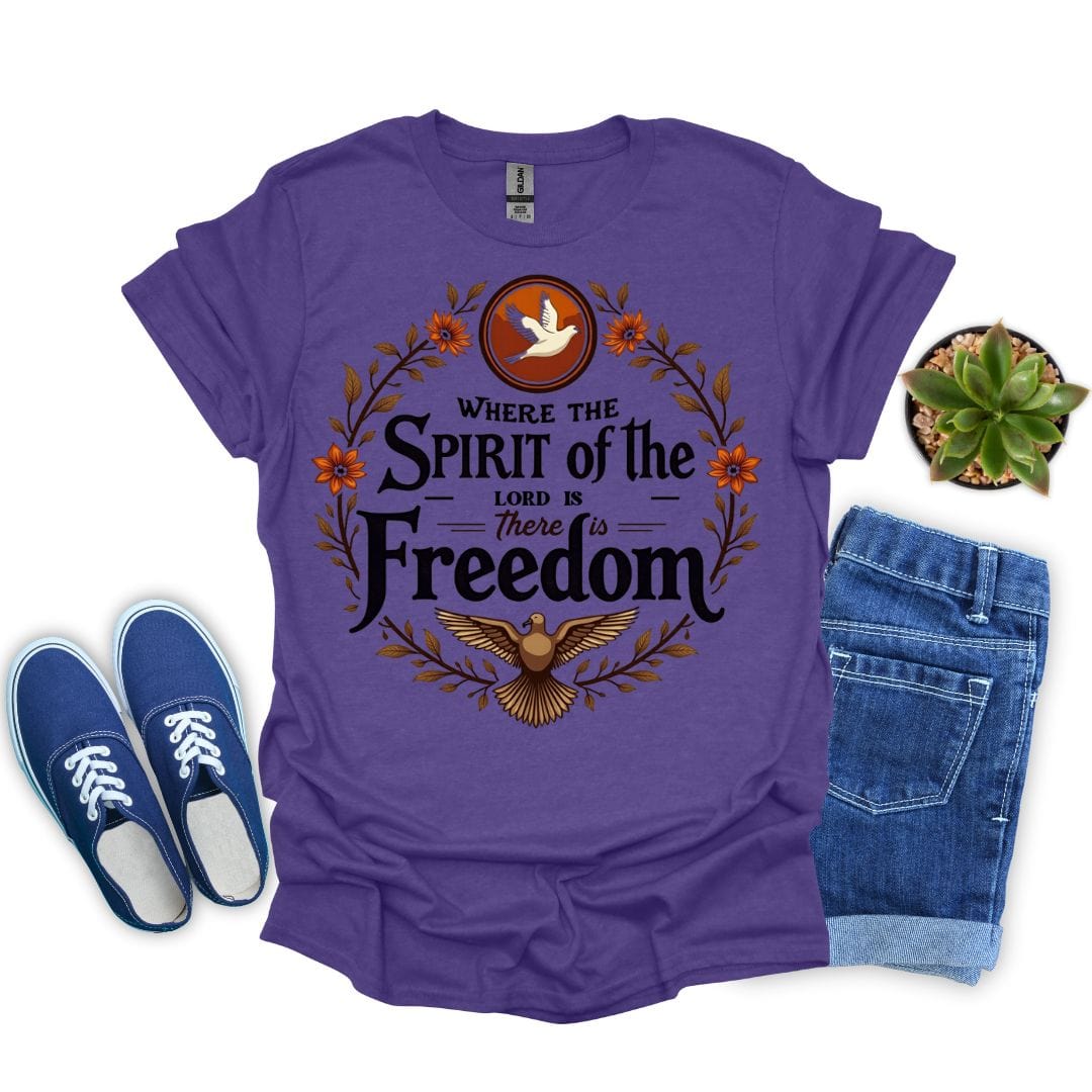 Heather purple t-shirt with 'Where the Spirit of the Lord is, There is Freedom' design, blue sneakers, and jeans on a white background.