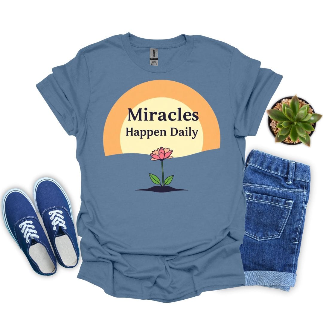 Indigo blue t-shirt with 'Miracles Happen Daily' graphic, blue sneakers, and denim shorts on a white background.