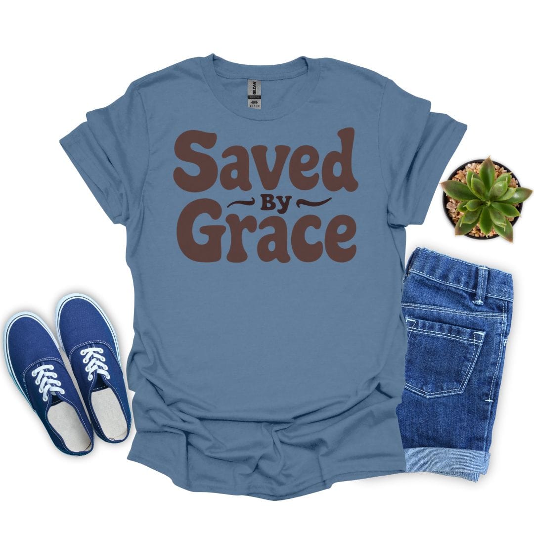 Indigo blue t-shirt with 'Saved by Grace' text, blue sneakers, and denim shorts on a white background.