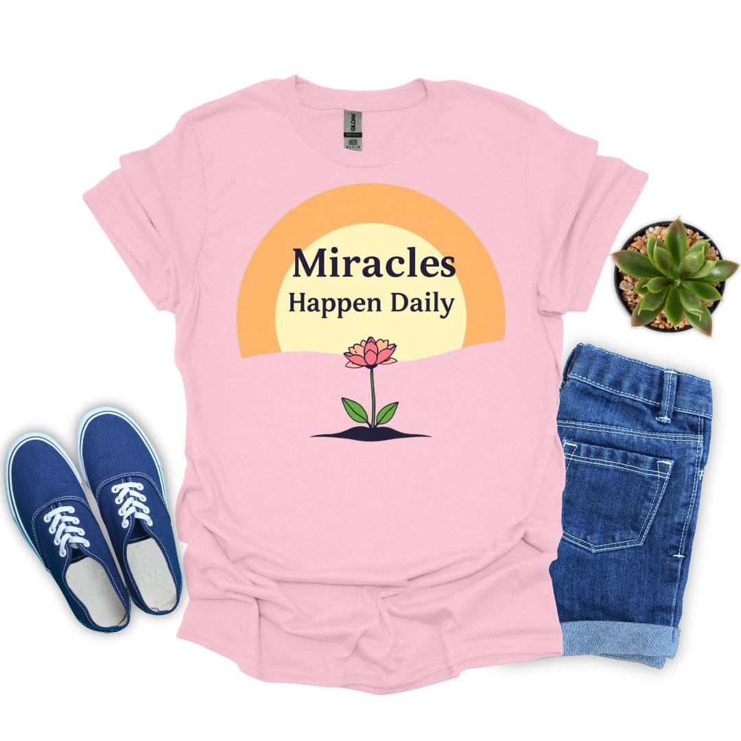 light pink t-shirt with 'Miracles Happen Daily' design, blue sneakers, and denim shorts on a white background.