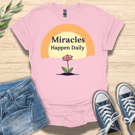 Light Pink unisex Christian T-shirt with ‘Miracles Happen Daily’ flower and sunrise design
