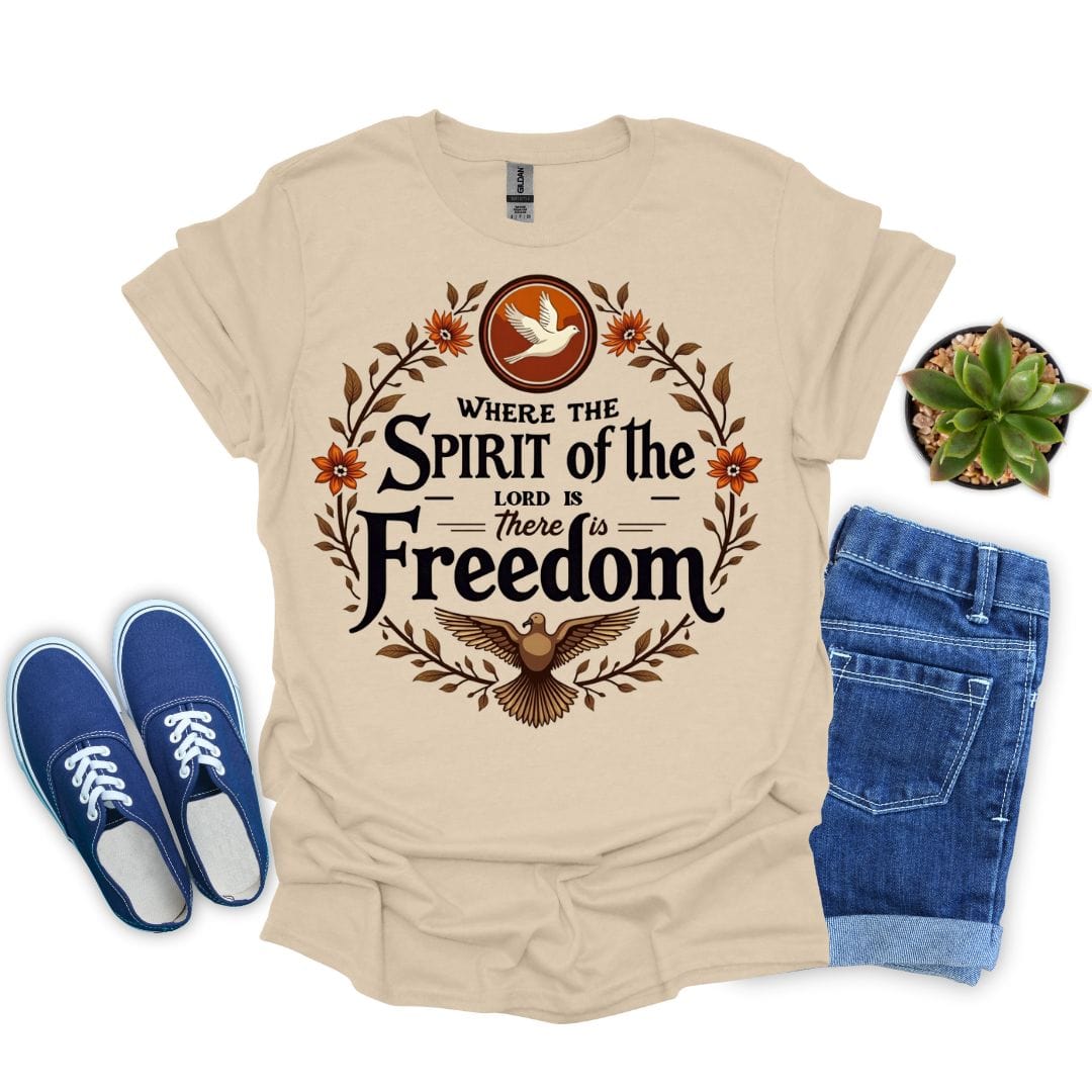 Sand t-shirt with 'Where the Spirit of the Lord is, there is Freedom' design, blue sneakers, and jeans on a white background.